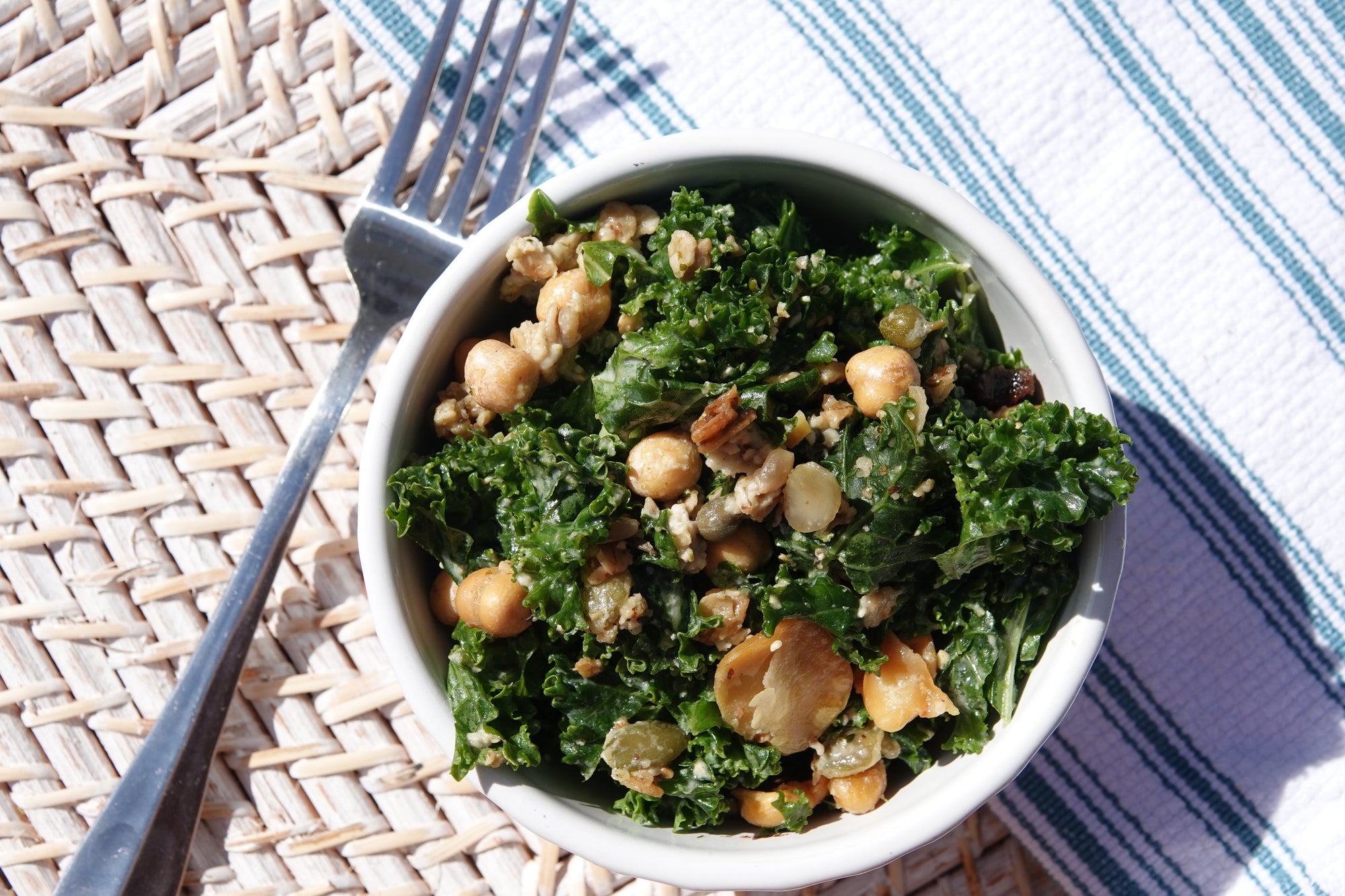 absurd snacks allergy free trail mix on top of kale caesar salad perfect for an outdoor lunch
